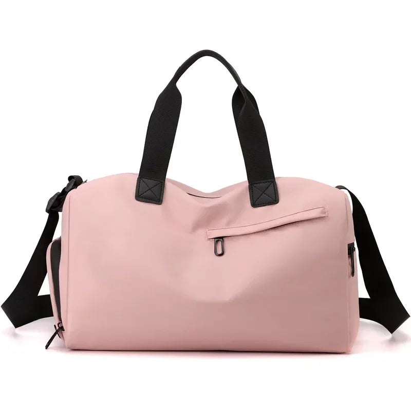 Pink duffel bag with black straps on a white background