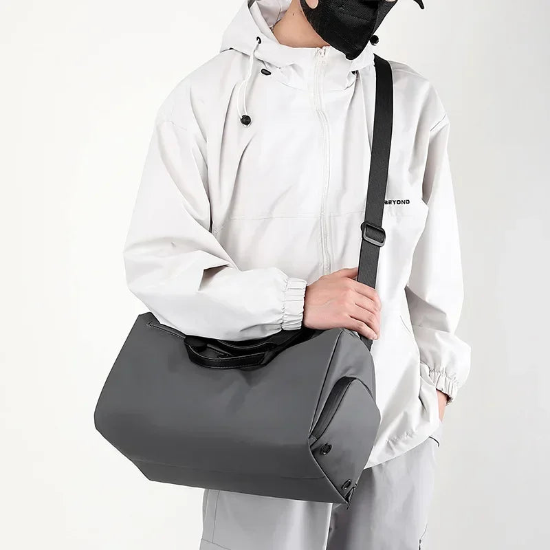 Person wearing a white raincoat holding a gray bag with a black strap on a white background